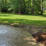 Water flows from a pipe, draining a flooded area