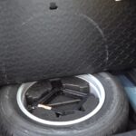 The spare tire and jack are neatly stored beneath the cargo area floor