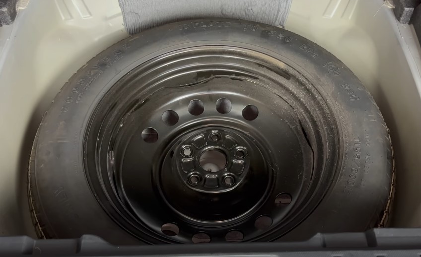 Spare tire neatly stored beneath the cargo area floor